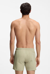 Back image of a model wearing the Boss iconic swimshorts in beige, by brand Boss