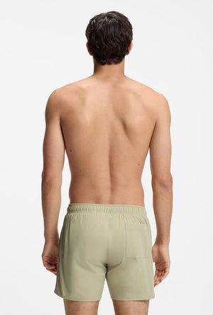 Back image of a model wearing the Boss iconic swimshorts in beige, by brand Boss