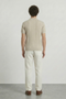 Back image of a model wearing the Deep colin zip polo in beige, by brand Deep