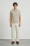 Front image of a model wearing Deep colin zip polo in beige, by brand Deep