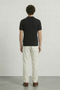 Back image of a model wearing the Deep colin zip polo in black, by brand Deep