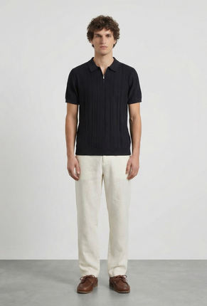 Front image of a model wearing Deep colin zip polo in black, by brand Deep