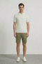 Front image of a model wearing Deep colin zip polo in white, by brand Deep