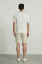 Back image of a model wearing the Deep connor round neck knit in white, by brand Deep