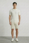 Front image of a model wearing Deep connor round neck knit in white, by brand Deep