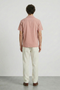 Back image of a model wearing the Deep fusion resort shirt in light pink, by brand Deep