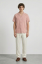 Front image of a model wearing Deep fusion resort shirt in light pink, by brand Deep