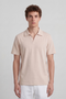 Front image of a model wearing the Deep leroy polo in peach, by brand Deep