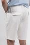 Back image of a model wearing the Deep new wave cotton shorts in off white, by brand Deep