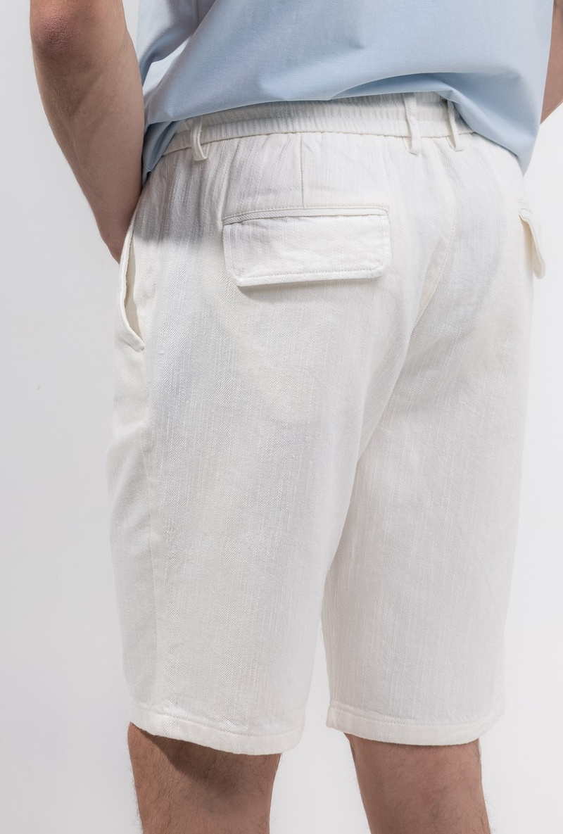 Back image of a model wearing Deep new wave cotton shorts in off white, by brand Deep