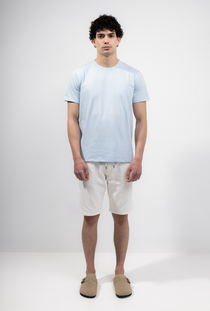 Front image of a model wearing the Deep new wave cotton shorts in off white, by brand Deep