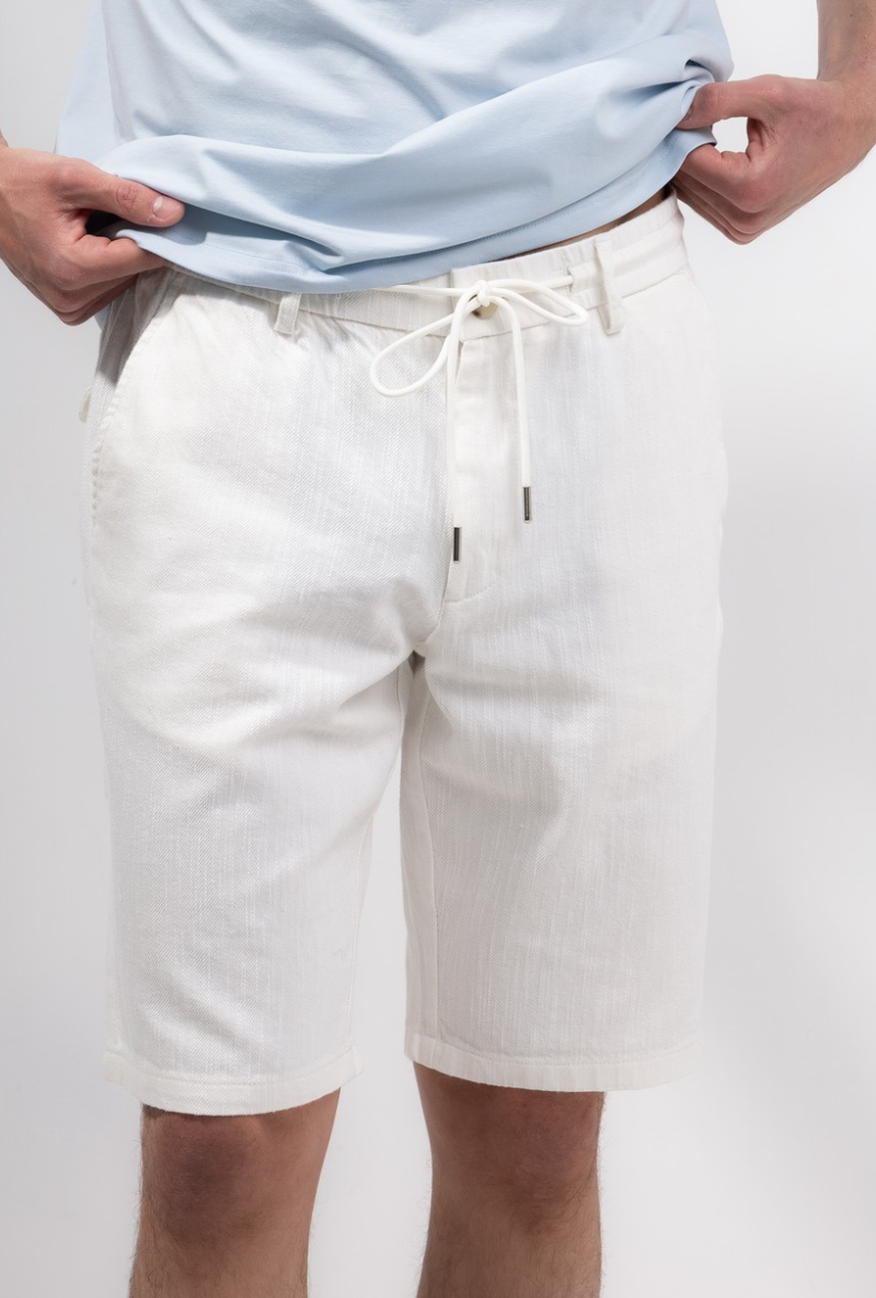 Front image of a model wearing Deep new wave cotton shorts in off white, by brand Deep
