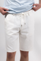 Front image of a model wearing the Deep new wave cotton shorts in off white, by brand Deep