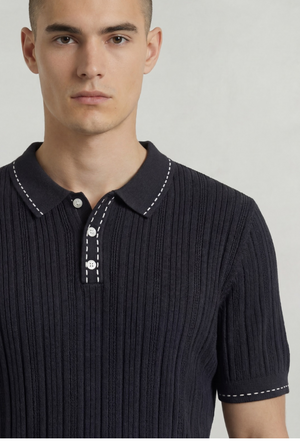 Front image of a model wearing the Deep river button knit polo in black, by brand Deep