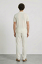 Back image of a model wearing the Deep rocco open neck polo in off white, by brand Deep