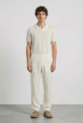 Front image of a model wearing Deep rocco open neck polo in off white, by brand Deep