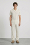 Front image of a model wearing Deep rocco open neck polo in off white, by brand Deep