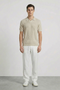Front image of a model wearing Deep rory open neck polo in beige, by brand Deep