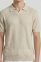 Front image of a model wearing the Deep rory open neck polo in beige, by brand Deep