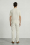 Back image of a model wearing the Deep ryker open neck polo in beige, by brand Deep