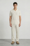 Front image of a model wearing Deep ryker open neck polo in beige, by brand Deep