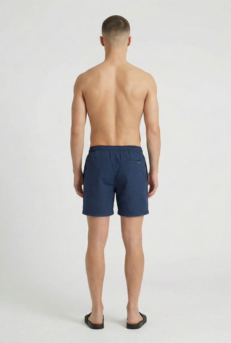 Back image of a model wearing Deep sharky swimshorts in navy, by brand Deep