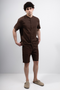 Front image of a model wearing Deep strike linen shirt in brown, by brand Deep