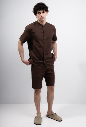 Front image of a model wearing the Deep strike linen shirt in brown, by brand Deep