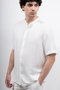 Front image of a model wearing the Deep strike linen shirt in off white, by brand Deep