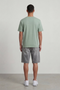 Back image of a model wearing the Deep troy s/s tshirt in khaki, by brand Deep