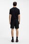 Back image of a model wearing the Dagety sweat shorts in black, by brand Hugo