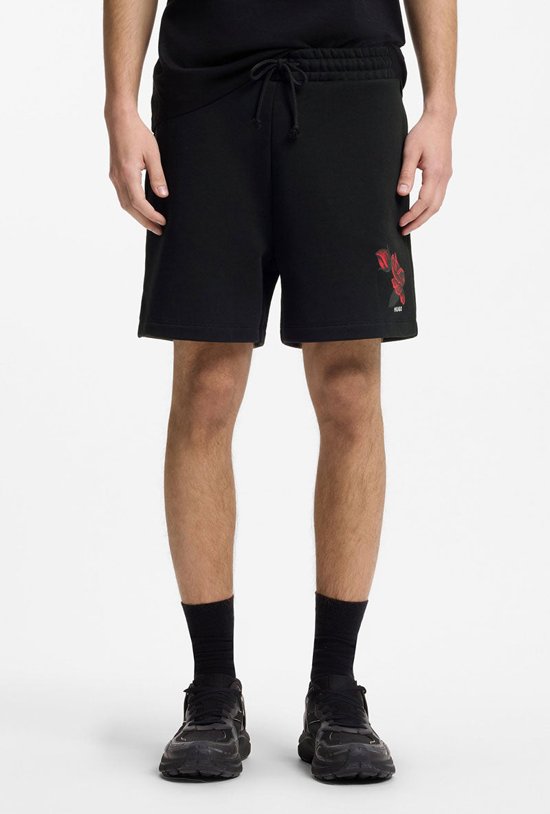 Front image of a model wearing Dagety sweat shorts in black, by brand Hugo