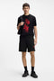 Front image of a model wearing the Dagety sweat shorts in black, by brand Hugo