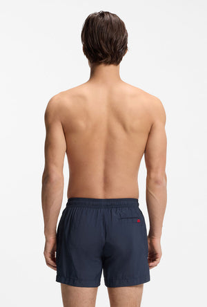 Back image of a model wearing the Dominica swimshorts in navy, by brand Hugo