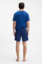 Back image of a model wearing the Laze shorts in blue, by brand Hugo