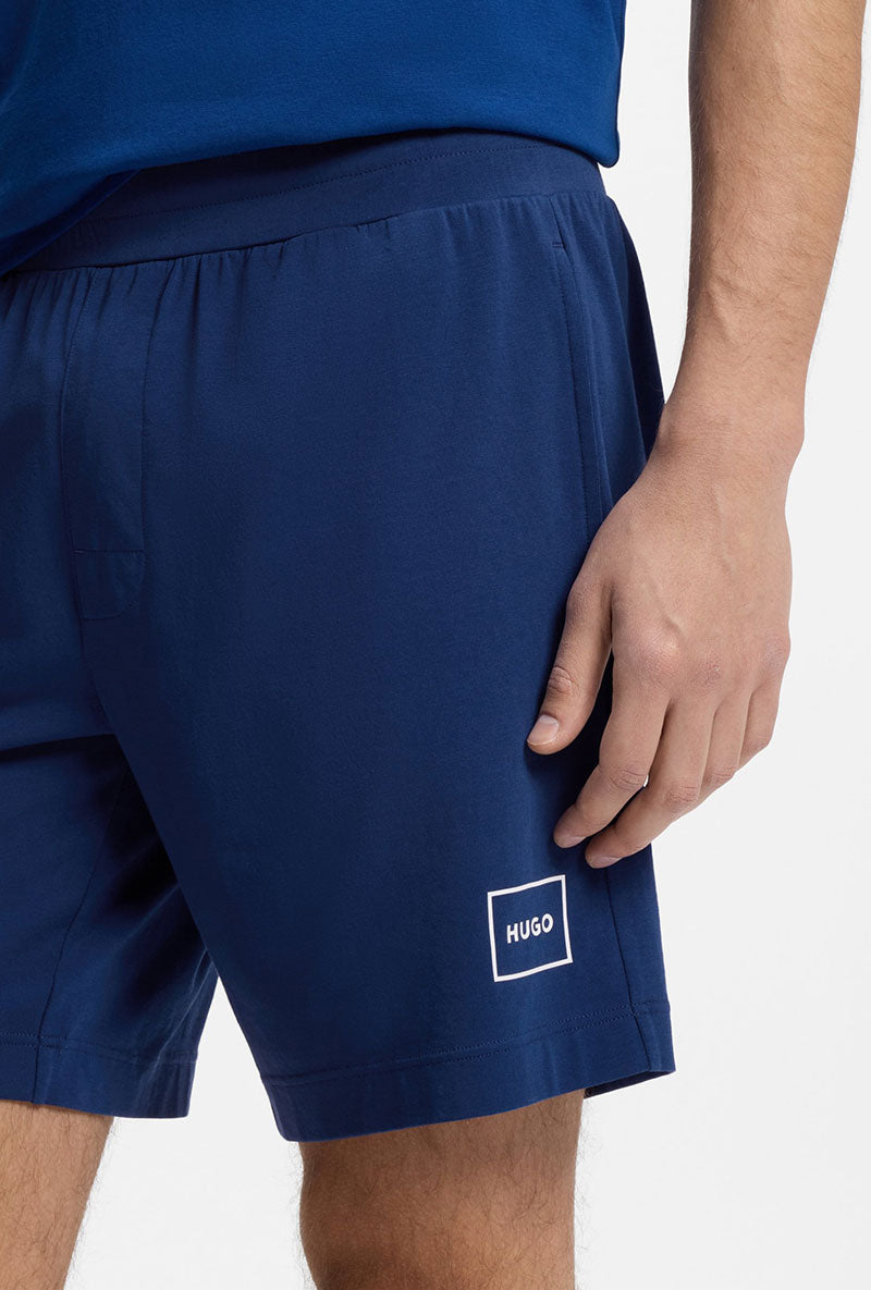 Front image of a model wearing Laze shorts in blue, by brand Hugo