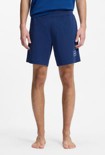Front image of a model wearing the Laze shorts in blue, by brand Hugo