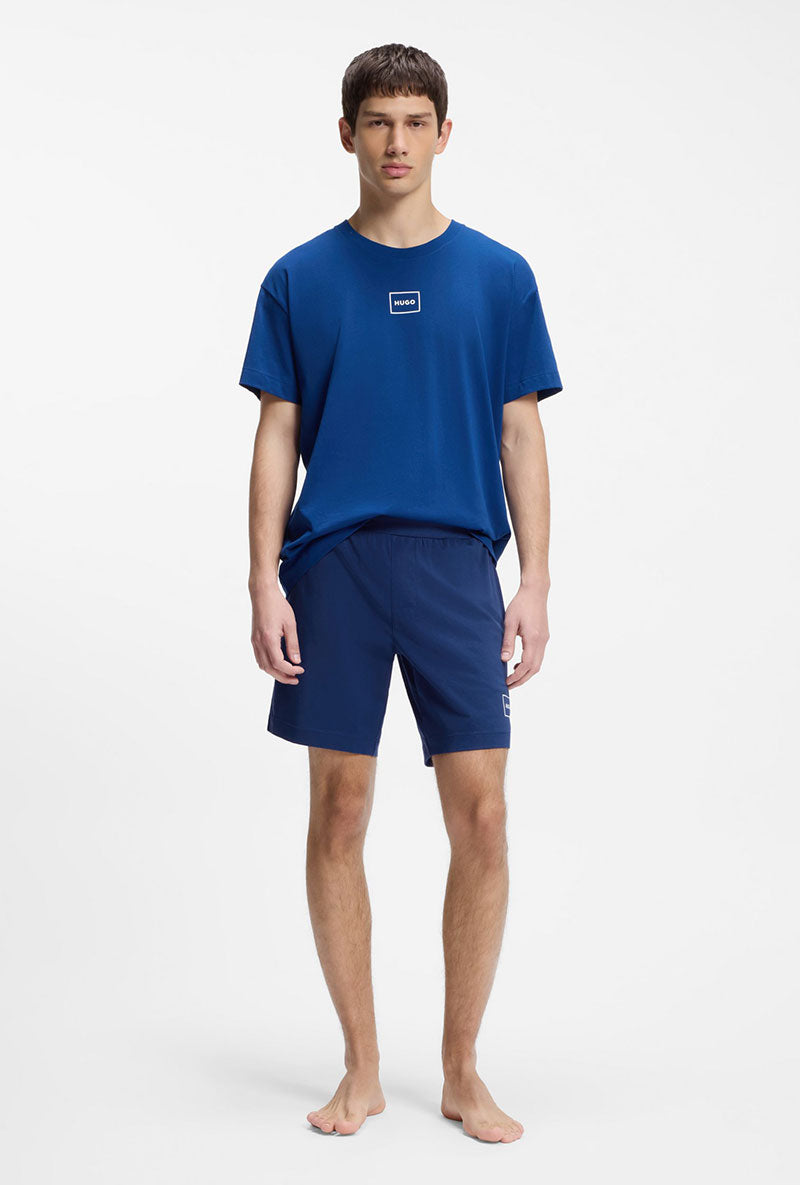 Front image of a model wearing Laze shorts in blue, by brand Hugo
