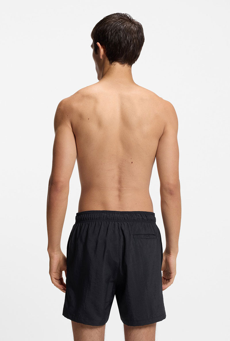 Back image of a model wearing Paolo swimshorts in black, by brand Hugo