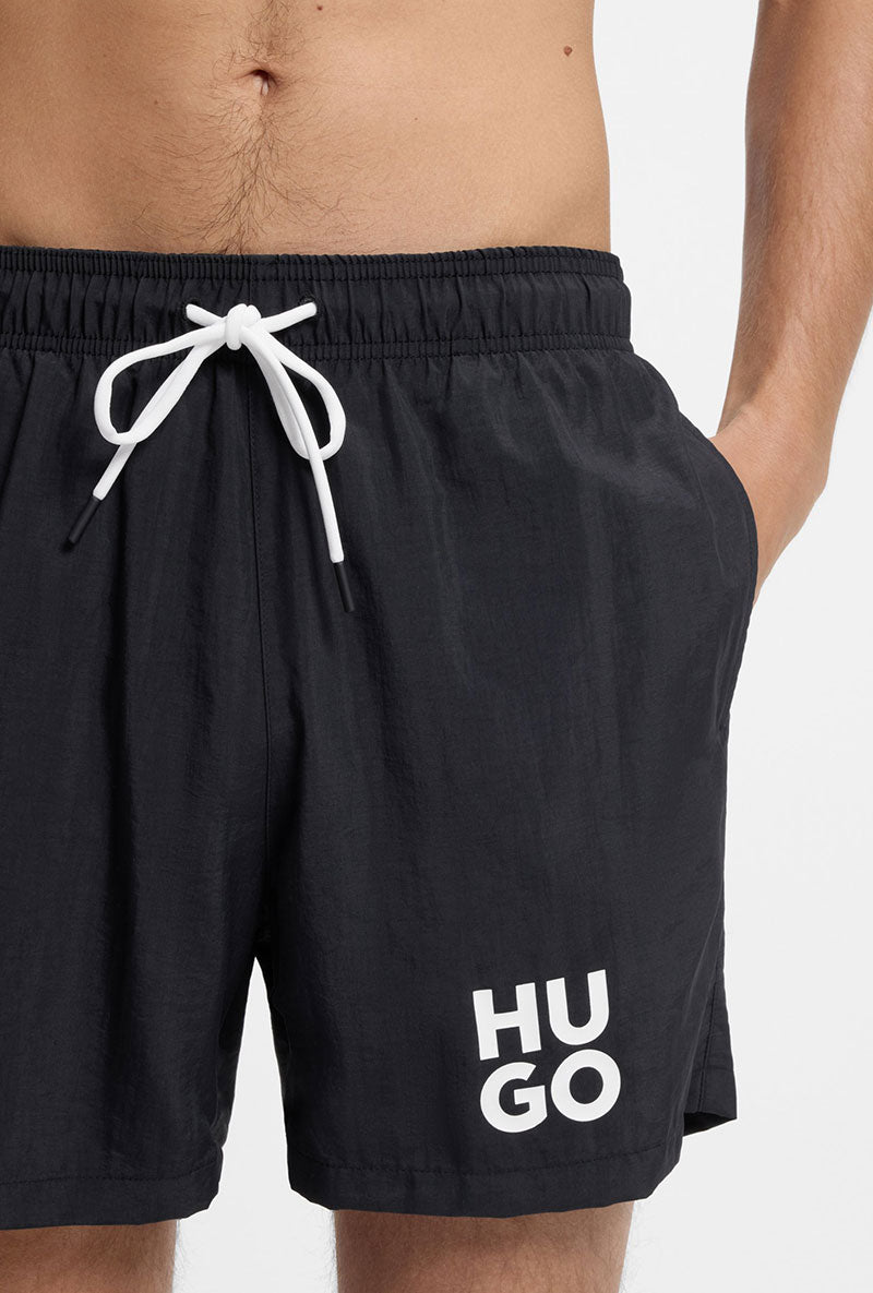 Front image of a model wearing Paolo swimshorts in black, by brand Hugo
