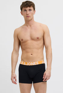 Front image of a model wearing the Jack and jones solid 3 pk trunks in black, by brand Jack&jones