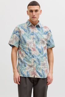 Front image of a model wearing the Honolulu aop ss shirt in off white, by brand Jack&jones