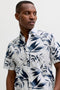 Front image of a model wearing the Honolulu aop ss shirt in white, by brand Jack&jones