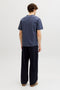 Back image of a model wearing the Montauk aop pocket tee in navy, by brand Jack&jones