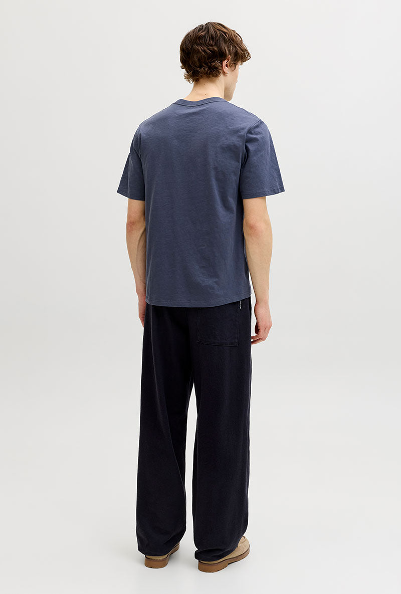 Back image of a model wearing Montauk aop pocket tee in navy, by brand Jack&jones