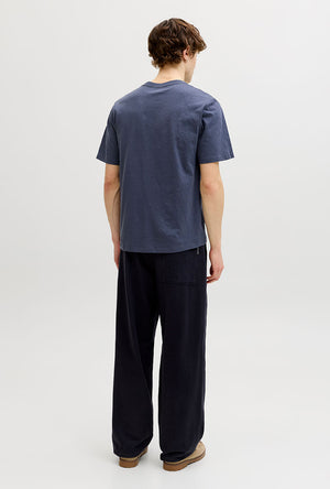 Back image of a model wearing the Montauk aop pocket tee in navy, by brand Jack&jones
