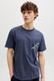 Front image of a model wearing the Montauk aop pocket tee in navy, by brand Jack&jones