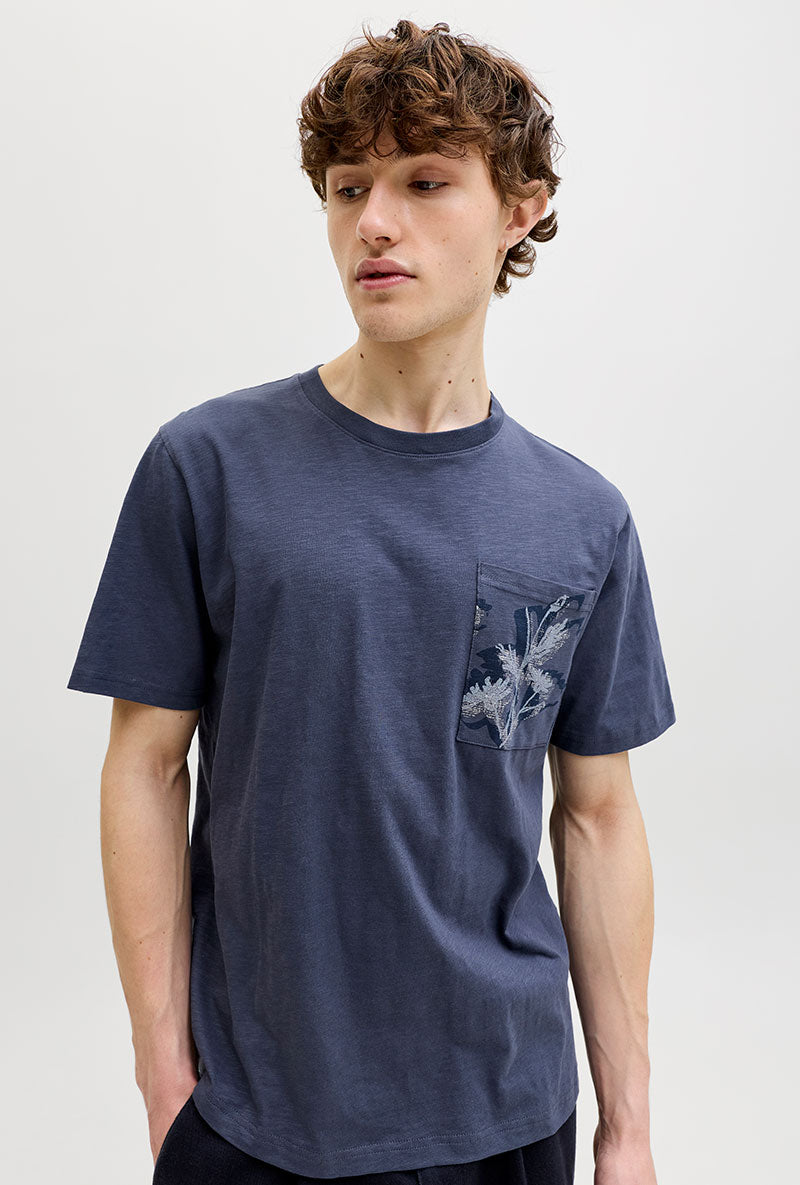 Front image of a model wearing Montauk aop pocket tee in navy, by brand Jack&jones