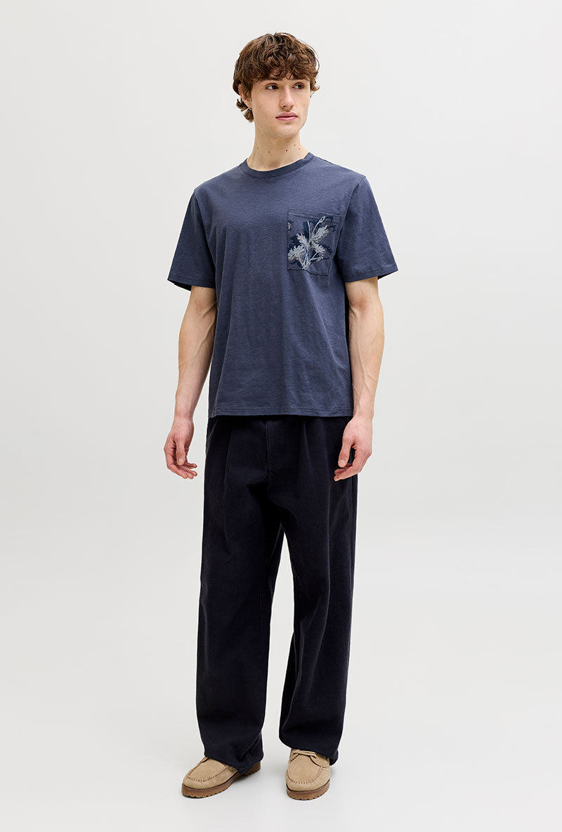 Front image of a model wearing Montauk aop pocket tee in navy, by brand Jack&jones