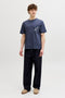 Front image of a model wearing the Montauk aop pocket tee in navy, by brand Jack&jones
